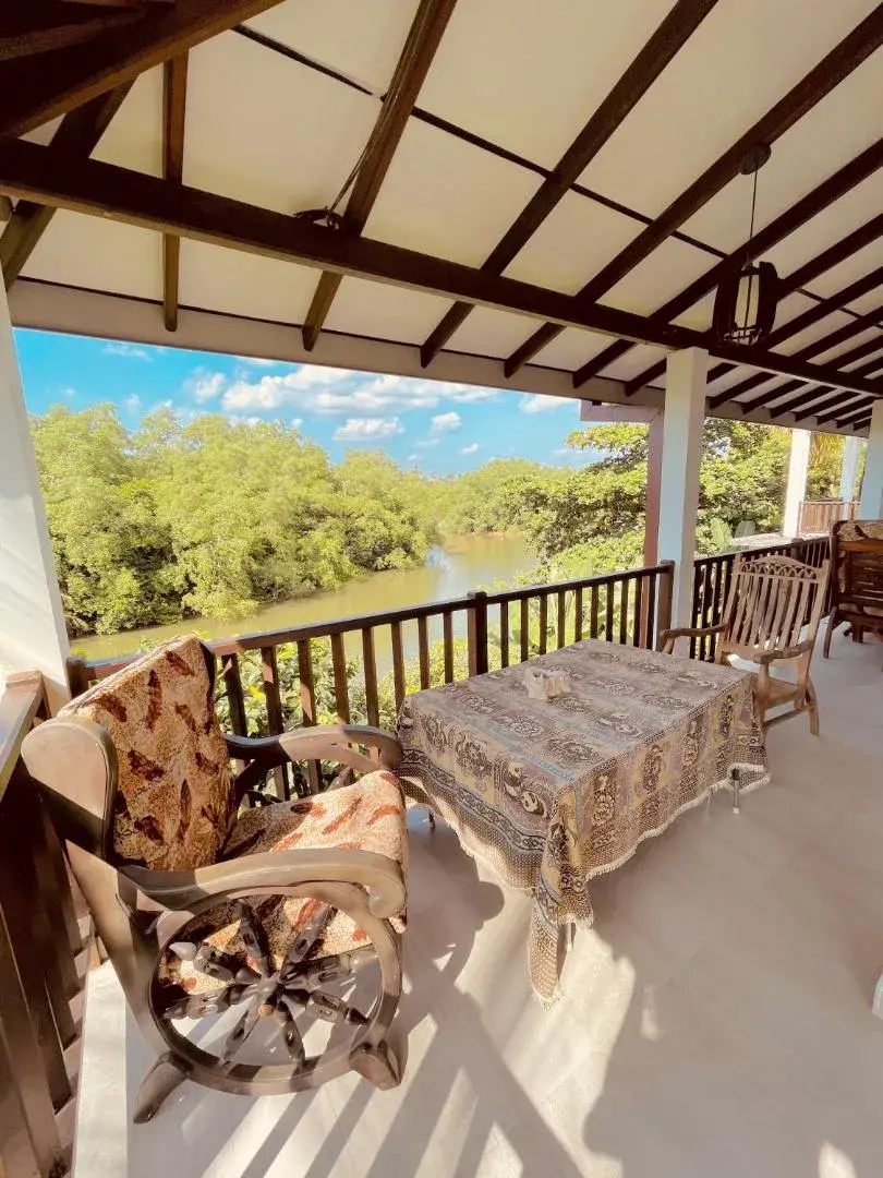 Covered balcony table and chairs overlooking the river