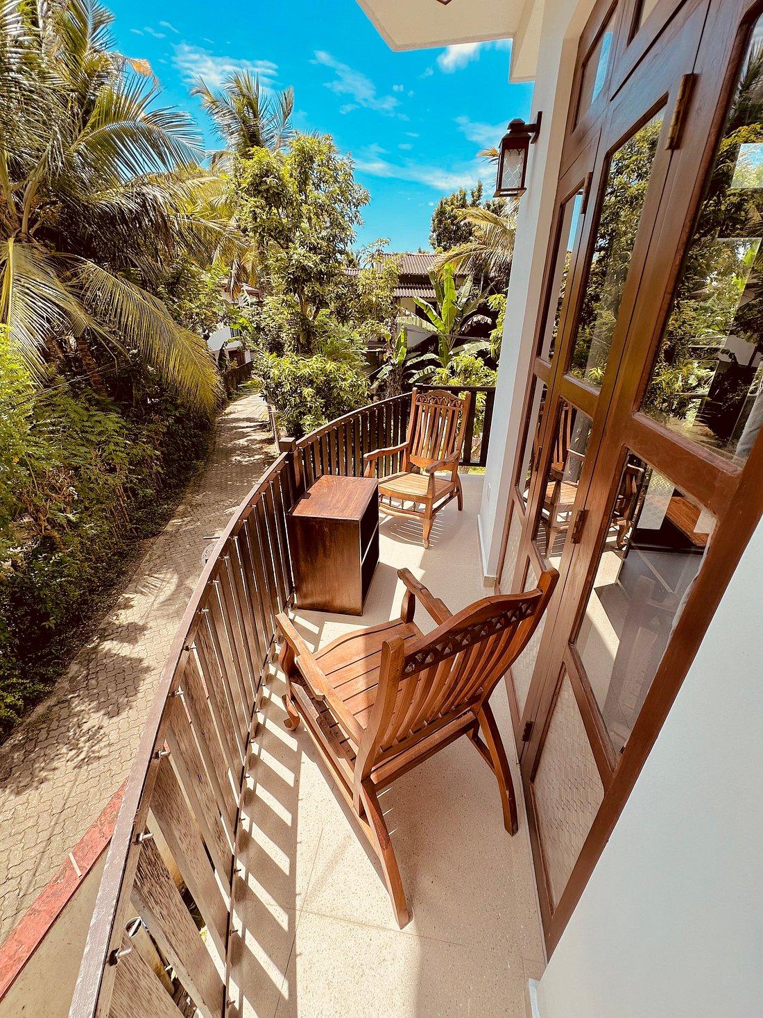 Wooden chairs on a balcony overlooking the garden path