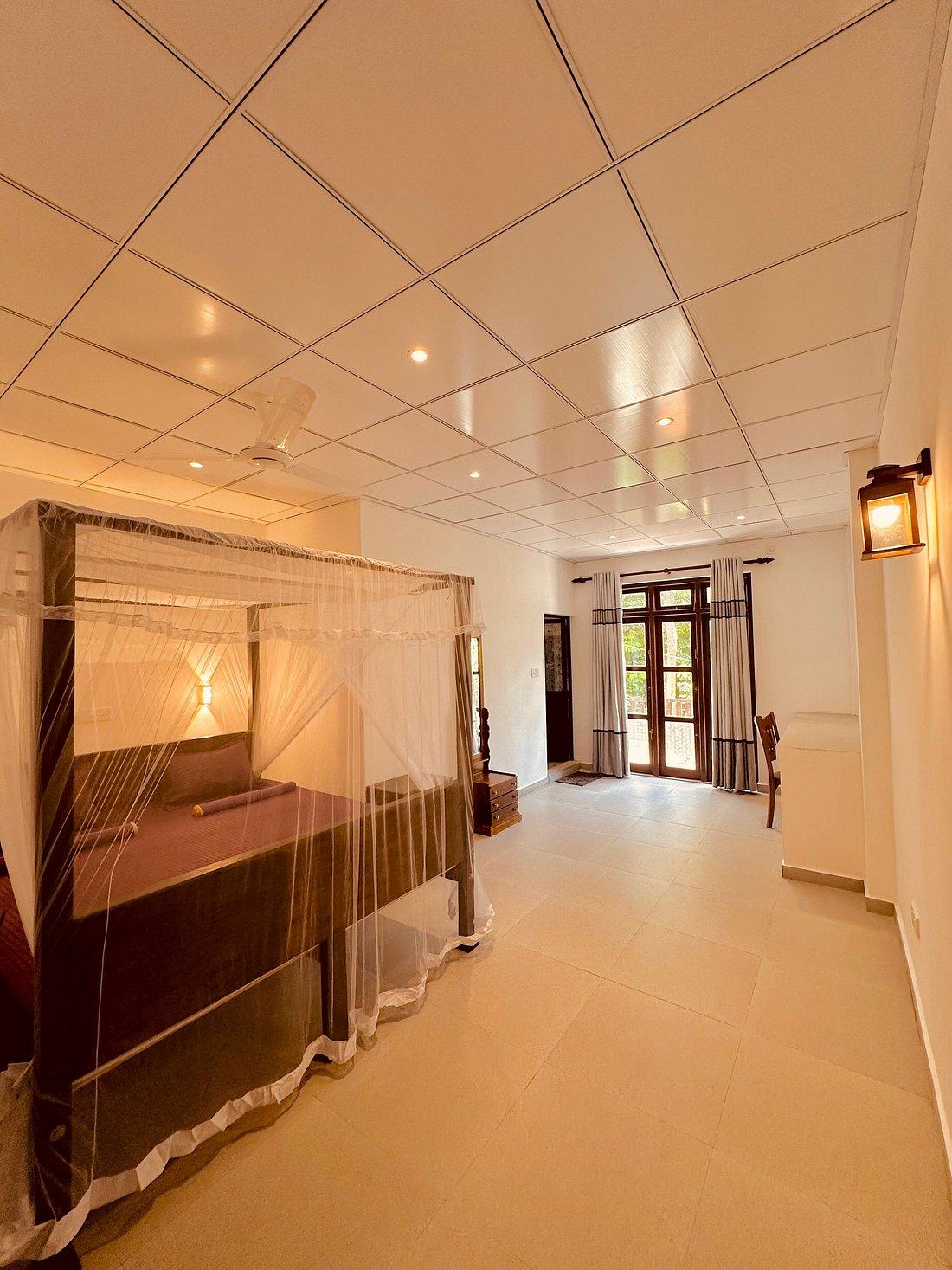 Warm bedroom with canopy bed and balcony doors