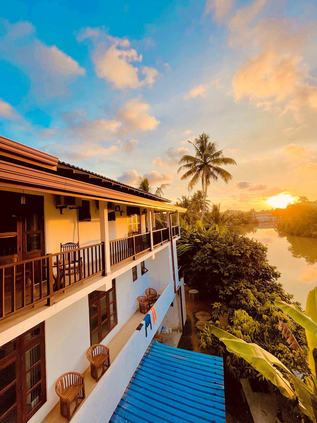 Riverwood Villa exterior beside the river at sunset
