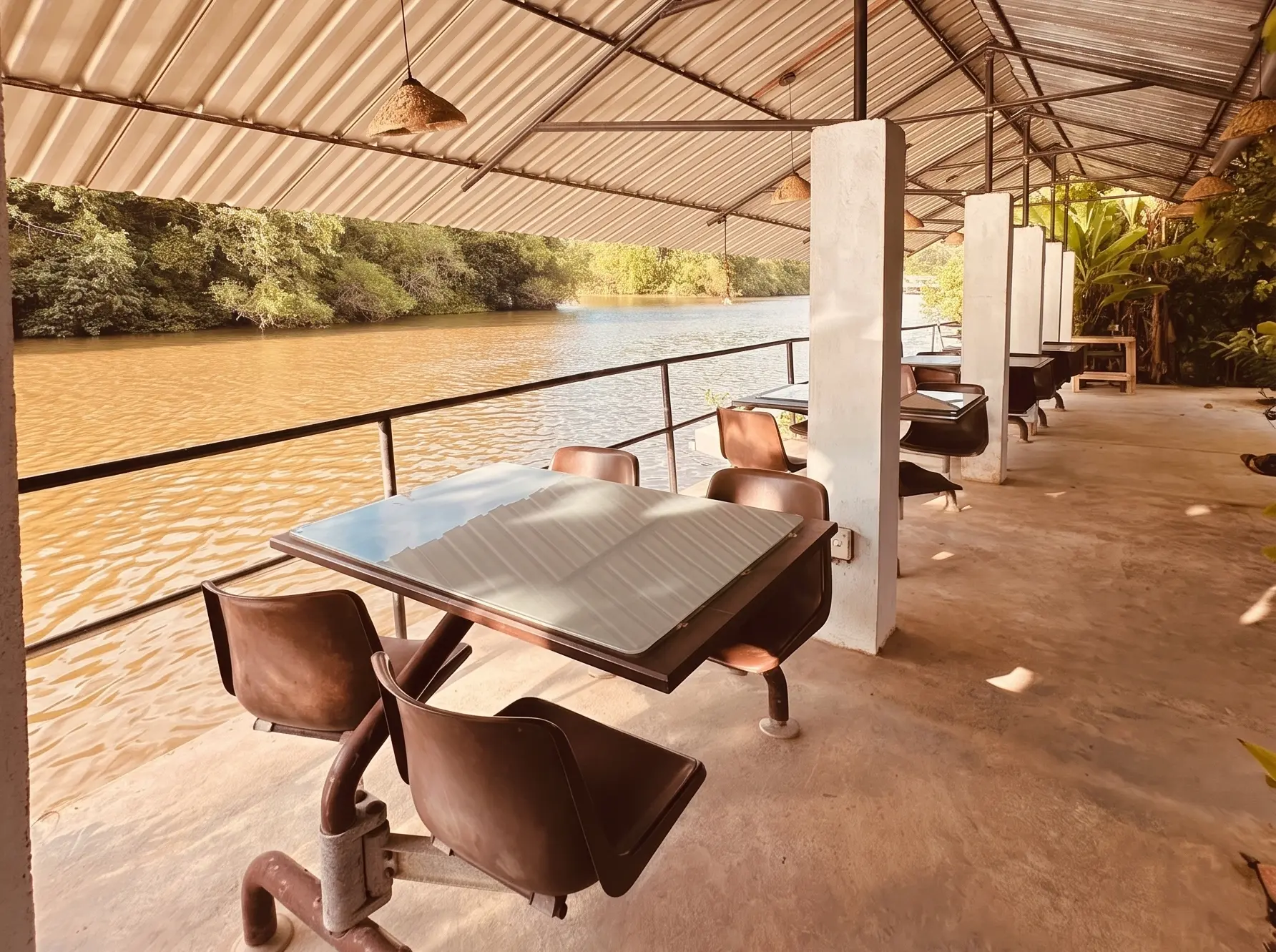 Shaded riverside dining terrace in the afternoon